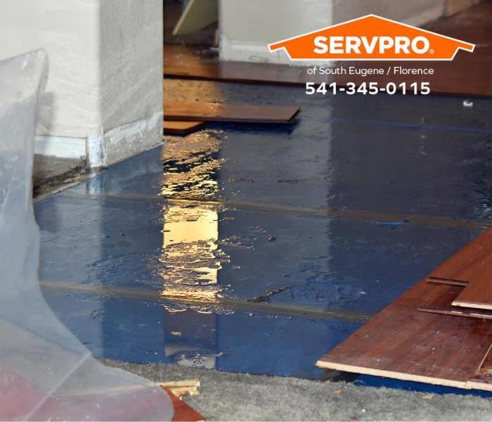 Floorboards are removed to discourage warping during the water damage mitigation process.